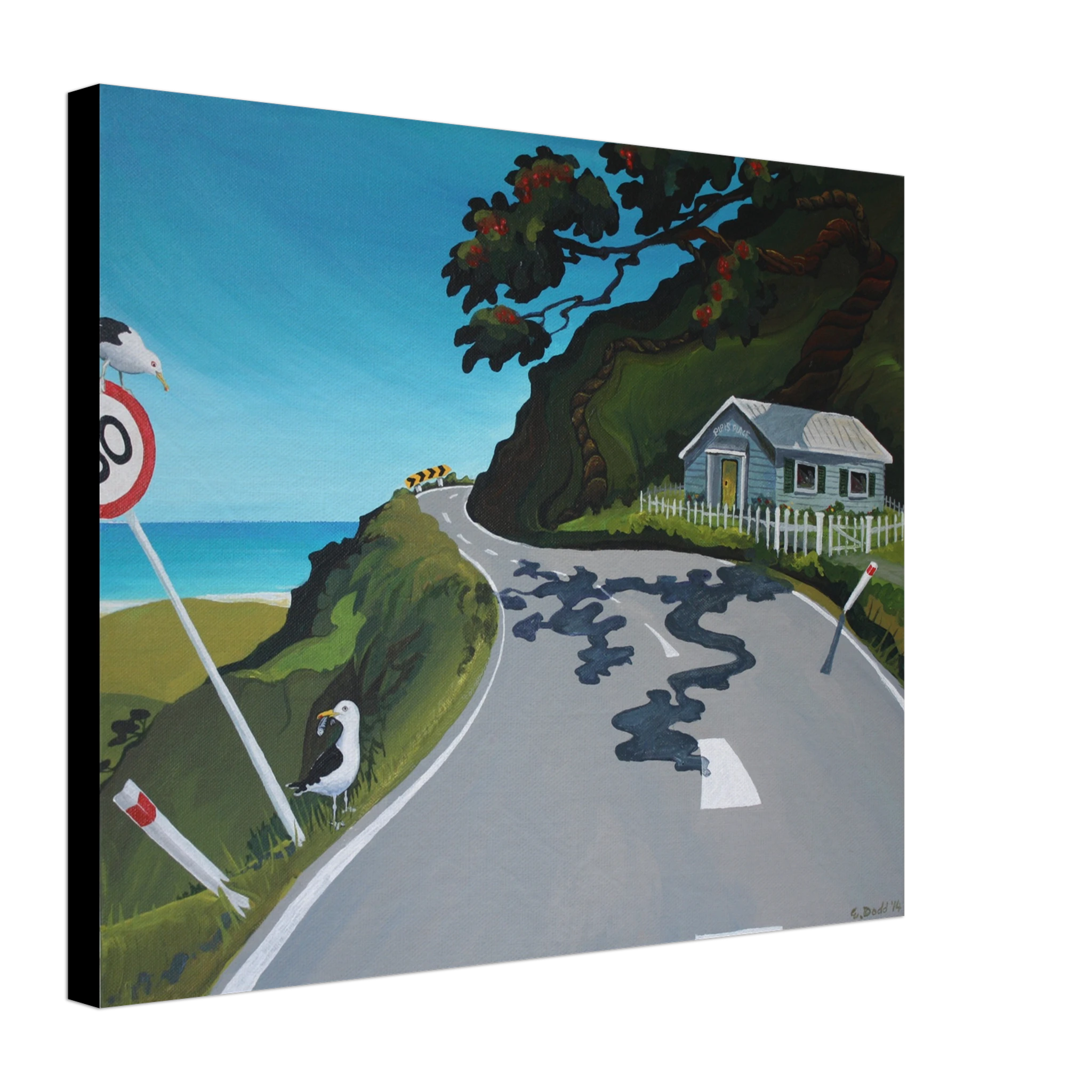 Angled view of a canvas print showing a winding coastal road, blue sea, cottage, tree, road sign, and two birds.