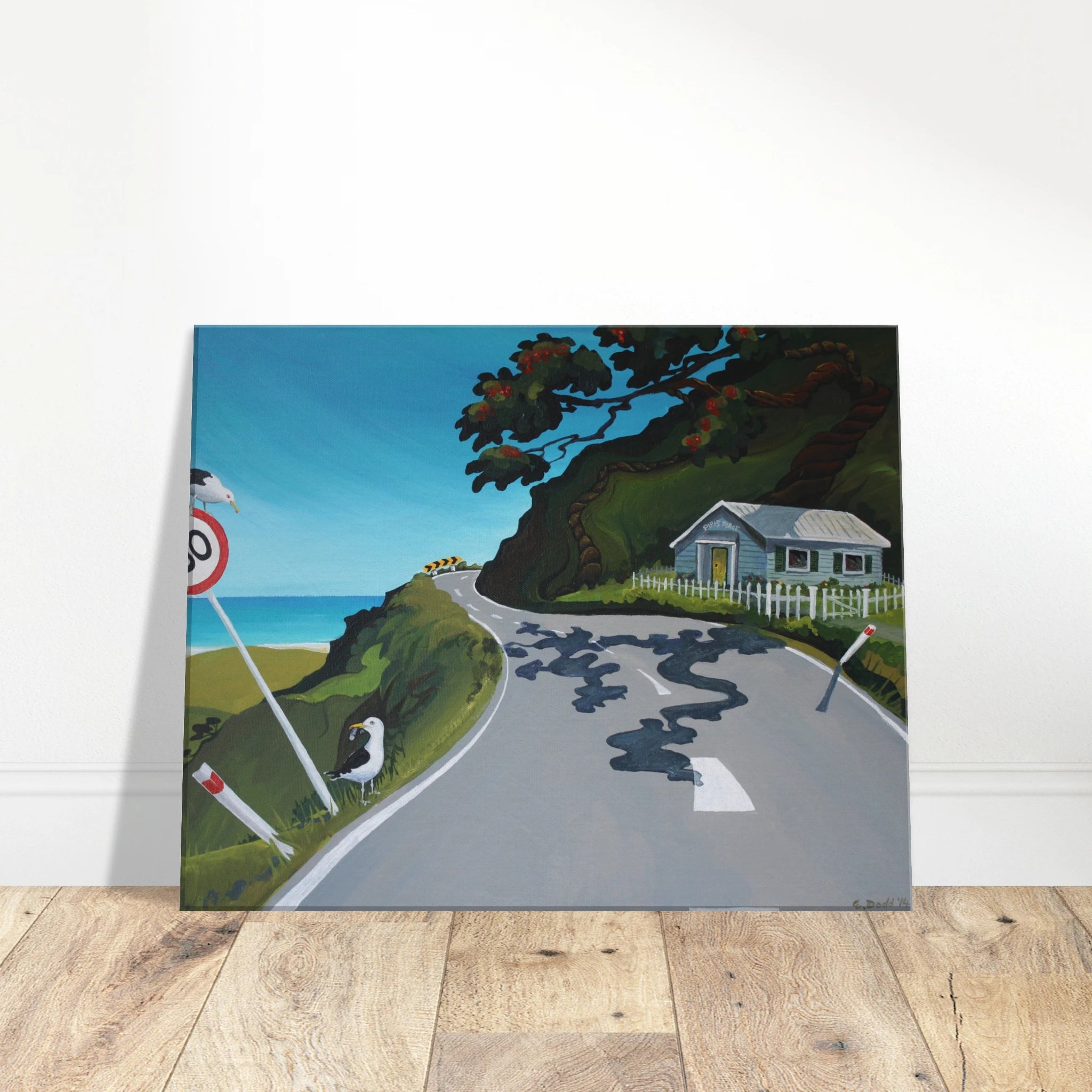 Canvas print leaning against a wall on a wooden floor.