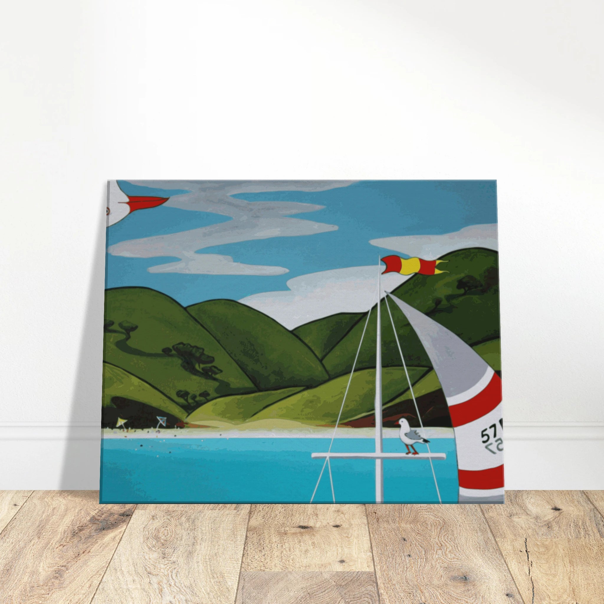 Front view of a square canvas print showing blue water, green hills, a cropped sailboat, and a seagull.