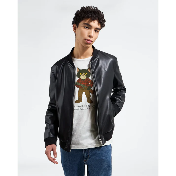 Model wearing a white T-shirt with cat illustration under a black jacket