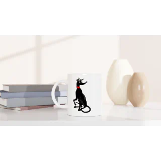 White ceramic mug with black greyhound illustration styled on a tabletop with books and vases