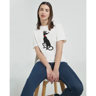 Woman seated wearing white t-shirt with black greyhound illustration