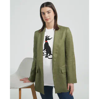 Woman standing in green blazer wearing white t-shirt with black greyhound illustration