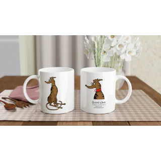 Two white mugs on a table, one with brindle greyhound illustration and one with logo