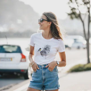 Woman wearing white t-shirt with dog and bird illustration