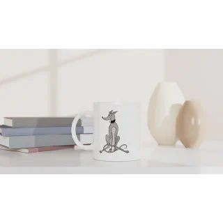 White mug with grey greyhound illustration on a shelf beside books and vases