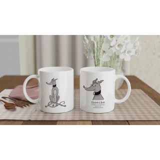 Two white mugs with grey greyhound artwork on a table beside flowers