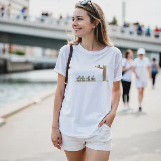 Model wearing white T-shirt with cartoon cats and birds design