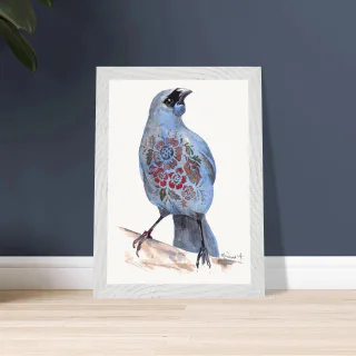 White framed kokako print leaning against a dark blue wall