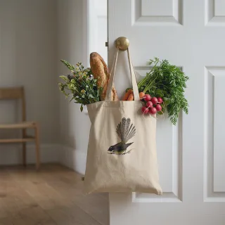 Angled natural tote bag with New Zealand fantail design