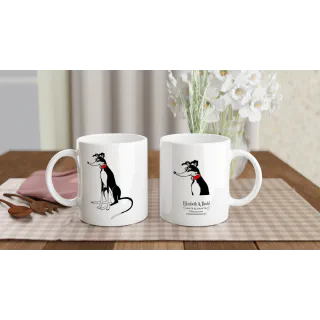 Two white ceramic mugs showing a greyhound illustration and logo on a table